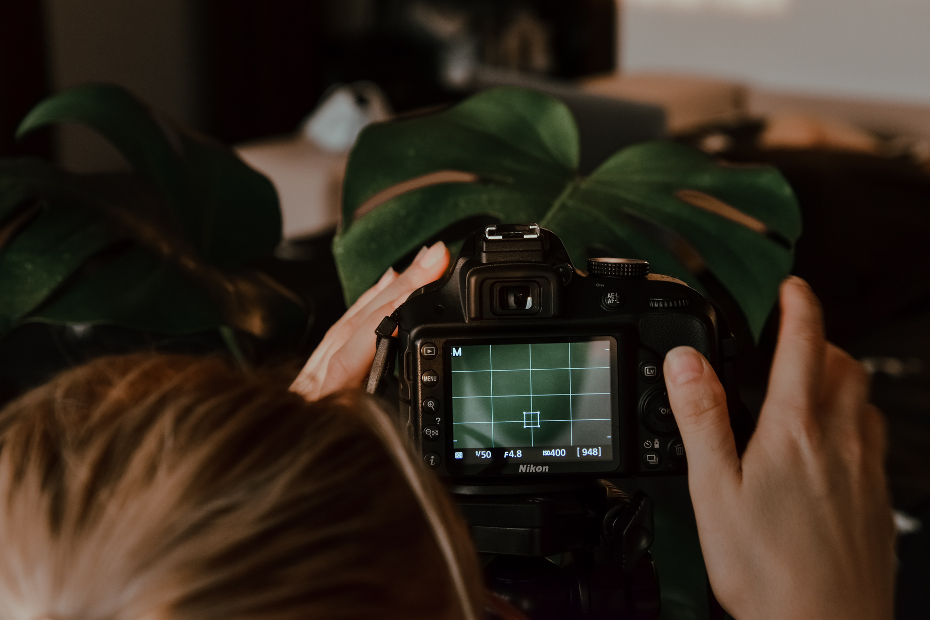 A Person Holding Black Nikon Dslr Camera